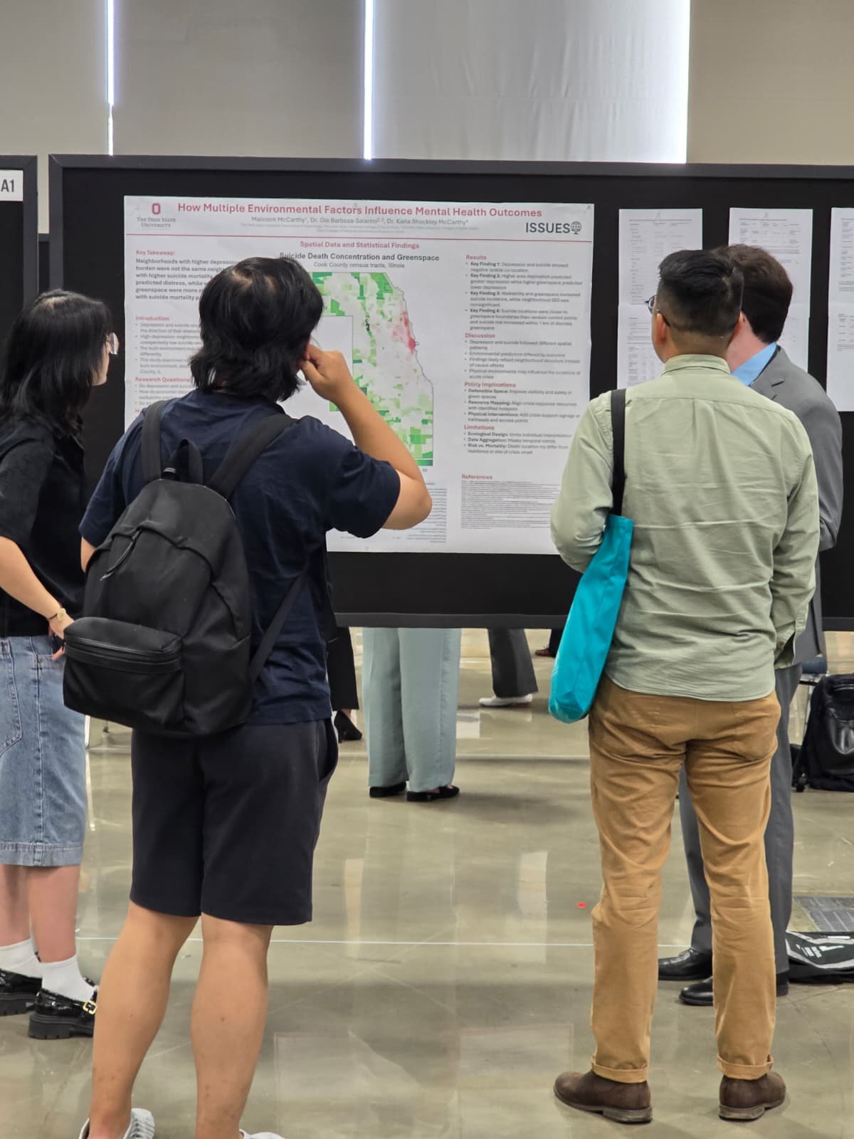Attendees viewing Malcolm's poster